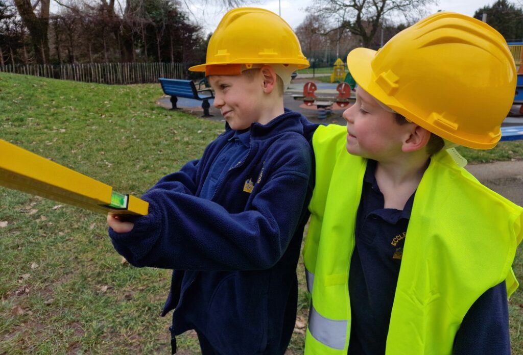 Two children with a spirit level