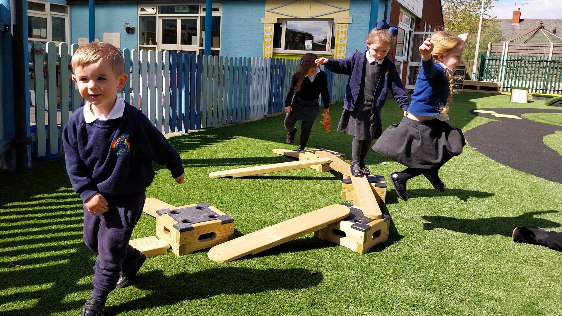 Children jumping off playground equipment