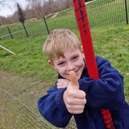 Boy on swing giving a thumbs up